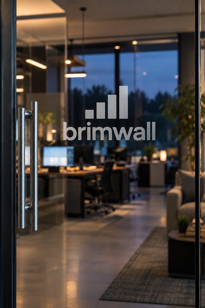Frosted BrimWall logo engraved on a glass office door